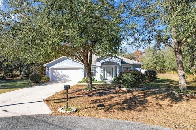 view of front of house with a garage and a front lawn