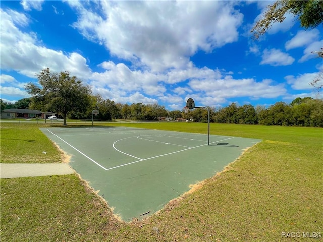 view of basketball court featuring a yard