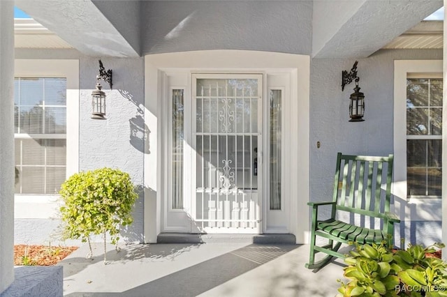 1923 W Mcneal Dr, Citrus Springs, FL 34434 - doorway to property with a porch and stucco siding