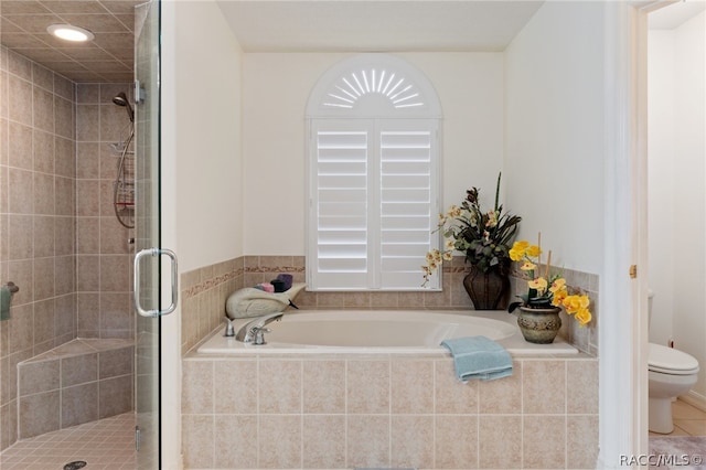 bathroom with tile patterned floors, toilet, and independent shower and bath