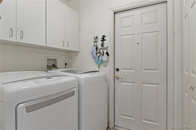 laundry room with cabinets and washer and clothes dryer