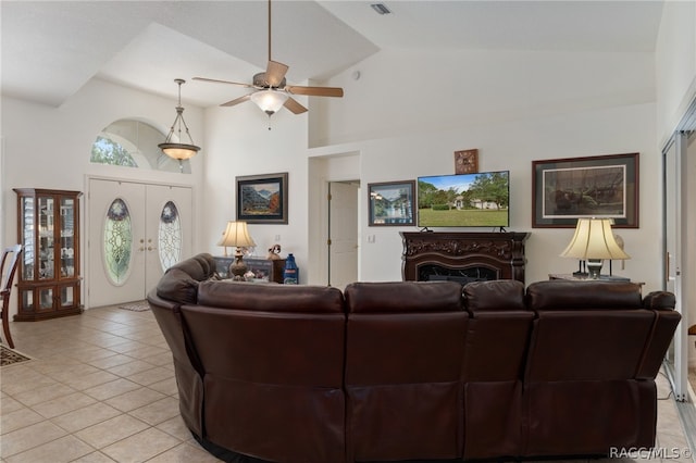 living room with ceiling fan, french doors, high vaulted ceiling, and light tile patterned floors