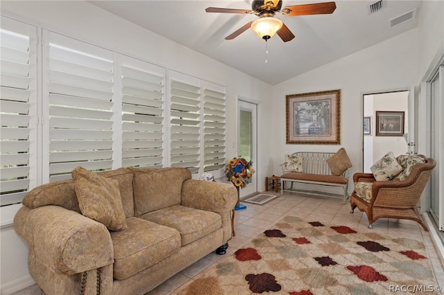 living room with light tile patterned floors, ceiling fan, and lofted ceiling