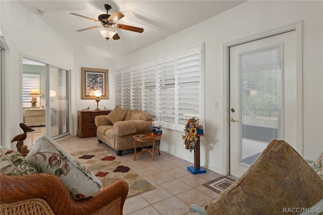 living room with ceiling fan, light tile patterned flooring, and a healthy amount of sunlight