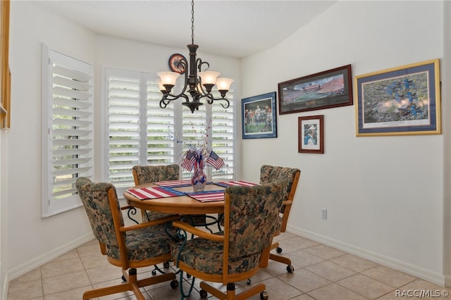 dining area featuring light tile patterned floors and a chandelier