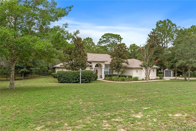 ranch-style home featuring a front yard