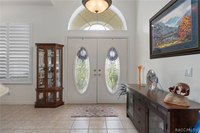 foyer entrance featuring light tile patterned floors and french doors