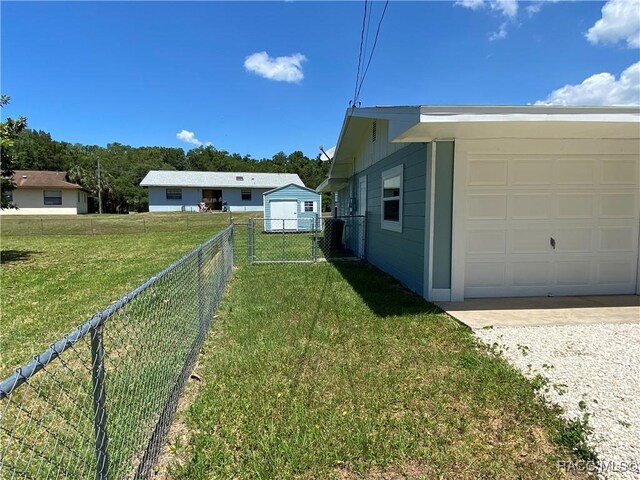 10765 W Spring Cir, Crystal River, FL 34428 - view of yard with a garage