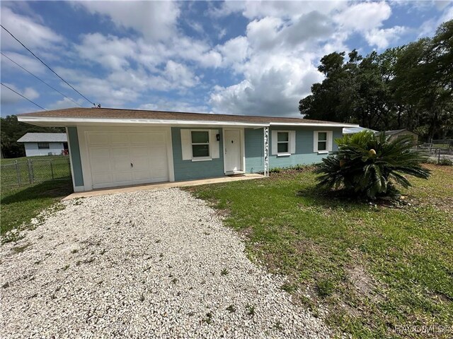 10765 W Spring Cir, Crystal River, FL 34428 - ranch-style home featuring an attached garage and gravel driveway