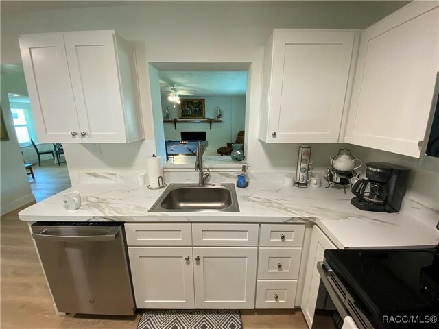 10765 W Spring Cir, Crystal River, FL 34428 - kitchen featuring stainless steel dishwasher, a sink, range with electric cooktop, white cabinetry, and ceiling fan