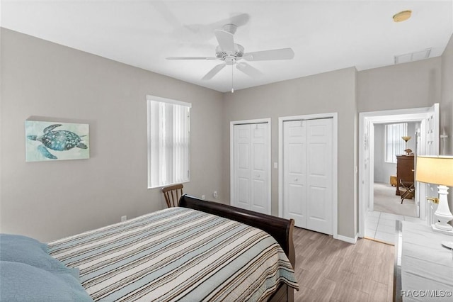 9989 N Langdon Rd, Citrus Springs, FL 34434 - bedroom with two closets, light wood-style floors, and ceiling fan