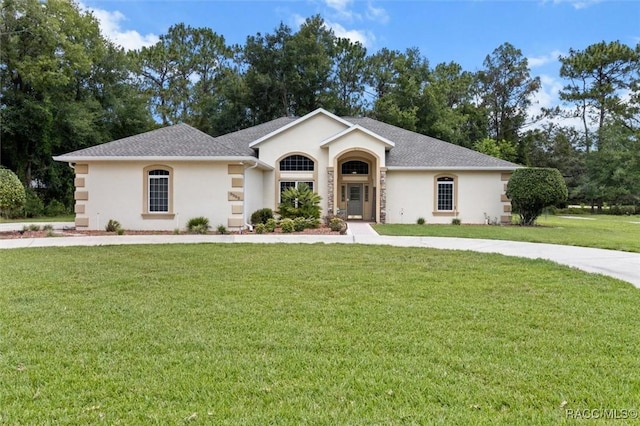 9989 N Langdon Rd, Citrus Springs, FL 34434 - ranch-style house with stucco siding, a front lawn, and a shingled roof