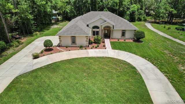 9989 N Langdon Rd, Citrus Springs, FL 34434 - ranch-style home with driveway, a front yard, and stucco siding