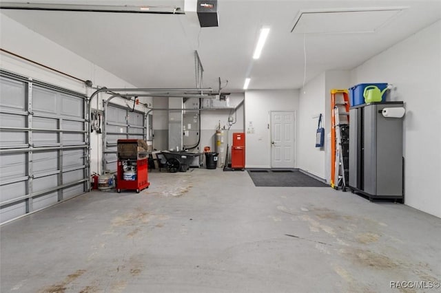 9989 N Langdon Rd, Citrus Springs, FL 34434 - garage featuring electric water heater and a garage door opener
