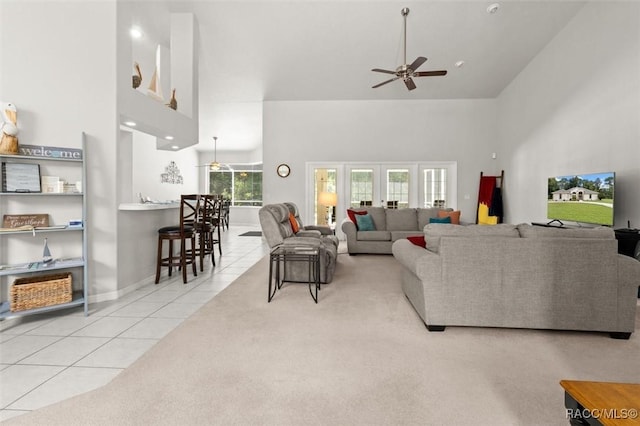 9989 N Langdon Rd, Citrus Springs, FL 34434 - living room with high vaulted ceiling, ceiling fan, light tile patterned floors, and light carpet