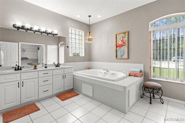 9989 N Langdon Rd, Citrus Springs, FL 34434 - full bathroom featuring plenty of natural light, a bath, double vanity, and tile patterned floors