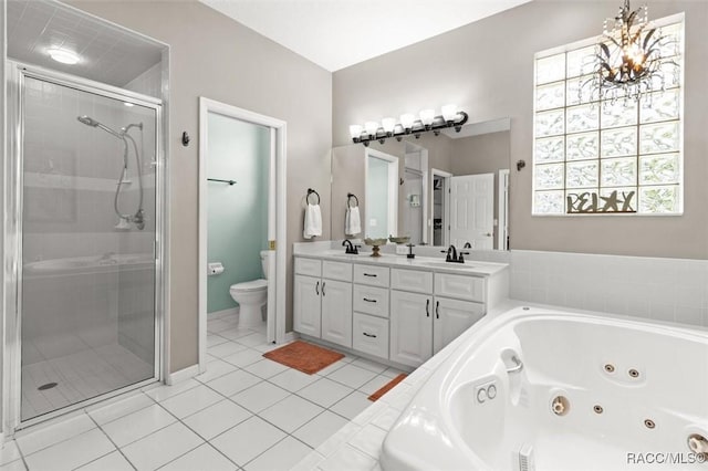 9989 N Langdon Rd, Citrus Springs, FL 34434 - bathroom with a tub with jets, double vanity, a shower stall, tile patterned floors, and a chandelier