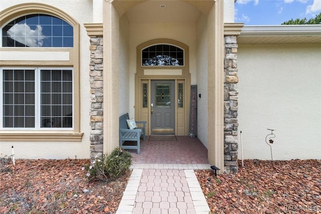 9989 N Langdon Rd, Citrus Springs, FL 34434 - property entrance featuring stucco siding, stone siding, and covered porch