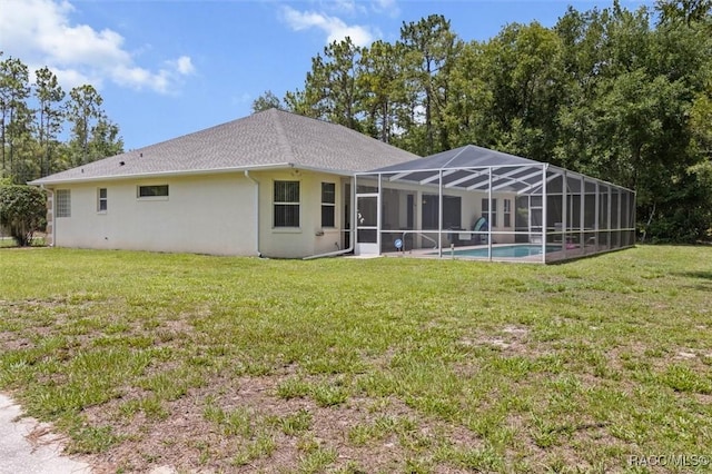 9989 N Langdon Rd, Citrus Springs, FL 34434 - rear view of property with stucco siding, a yard, an outdoor pool, and glass enclosure