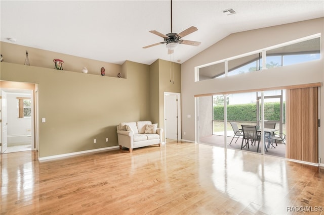 5694 W Hunters Ridge Cir, Lecanto, FL 34461 - living area featuring high vaulted ceiling, a ceiling fan, light wood-style flooring, and baseboards