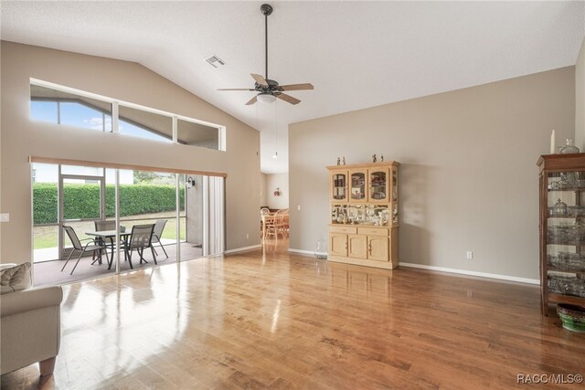 5694 W Hunters Ridge Cir, Lecanto, FL 34461 - living area with a ceiling fan, wood finished floors, high vaulted ceiling, and baseboards