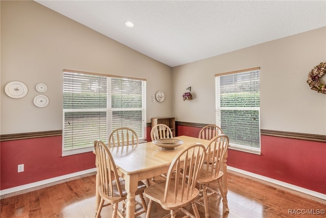 5694 W Hunters Ridge Cir, Lecanto, FL 34461 - dining space with wood finished floors, lofted ceiling, and baseboards