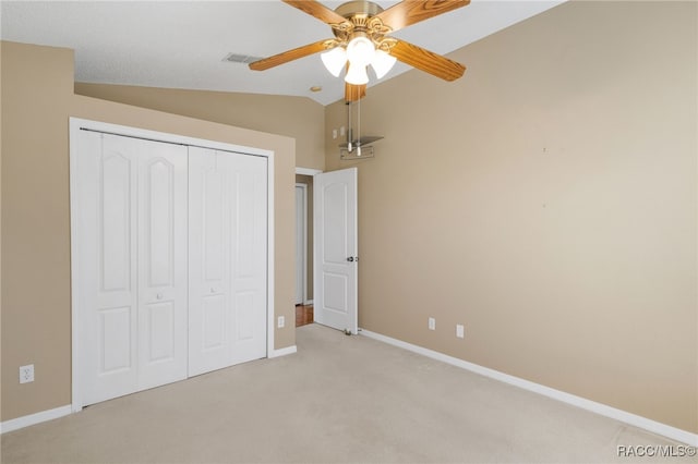 5694 W Hunters Ridge Cir, Lecanto, FL 34461 - unfurnished bedroom with vaulted ceiling, light colored carpet, a closet, baseboards, and ceiling fan