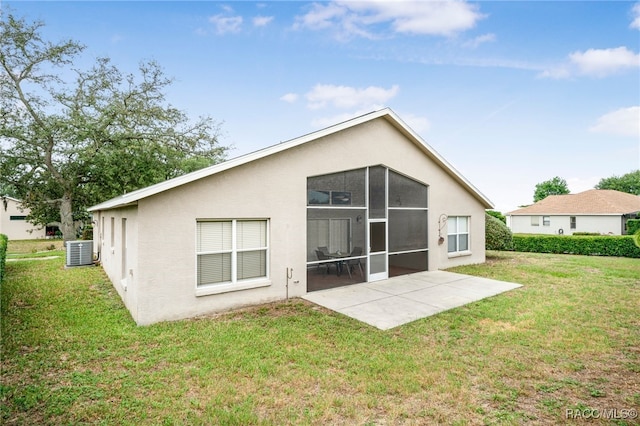 5694 W Hunters Ridge Cir, Lecanto, FL 34461 - rear view of house featuring central AC, a lawn, stucco siding, and a patio area