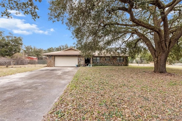 ranch-style home with a garage and a front lawn