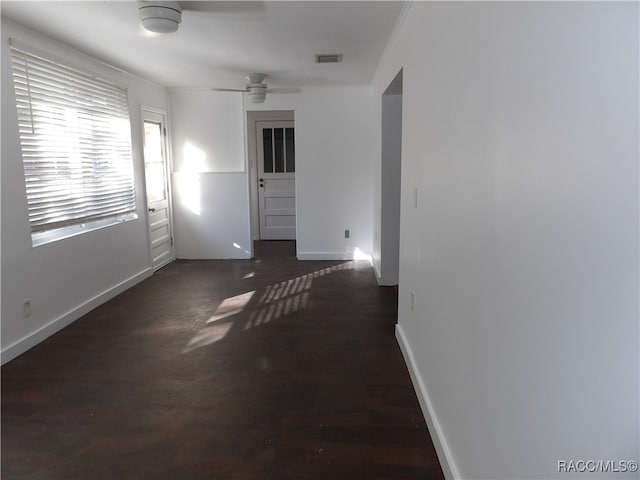 spare room featuring ceiling fan and dark wood-type flooring