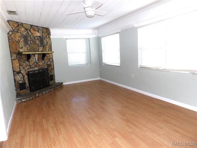 unfurnished living room with a fireplace, hardwood / wood-style floors, ceiling fan, and wooden ceiling