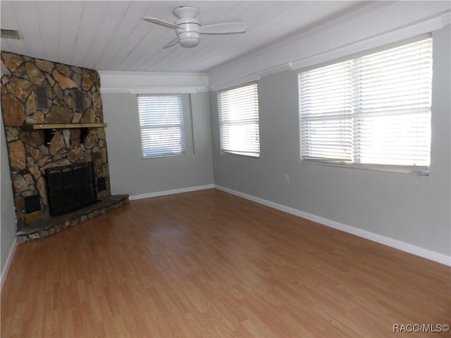 unfurnished living room featuring a stone fireplace, ceiling fan, hardwood / wood-style floors, and wood ceiling