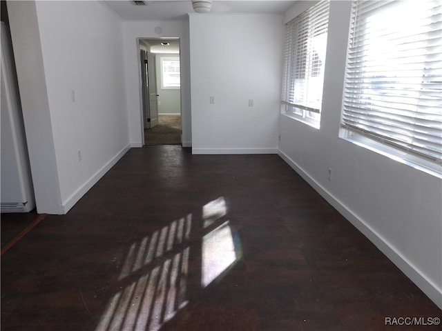 spare room featuring dark wood-type flooring