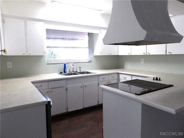 kitchen featuring kitchen peninsula, dark hardwood / wood-style flooring, sink, white cabinets, and range hood