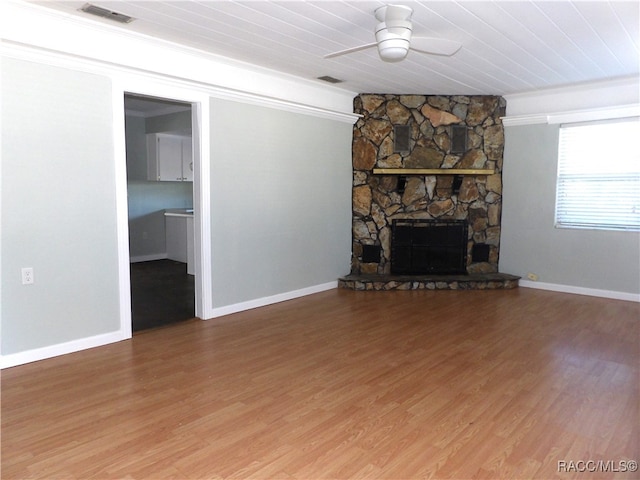 unfurnished living room featuring a fireplace, ceiling fan, hardwood / wood-style floors, and crown molding