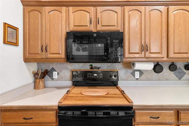 kitchen featuring black appliances, tasteful backsplash, and light countertops