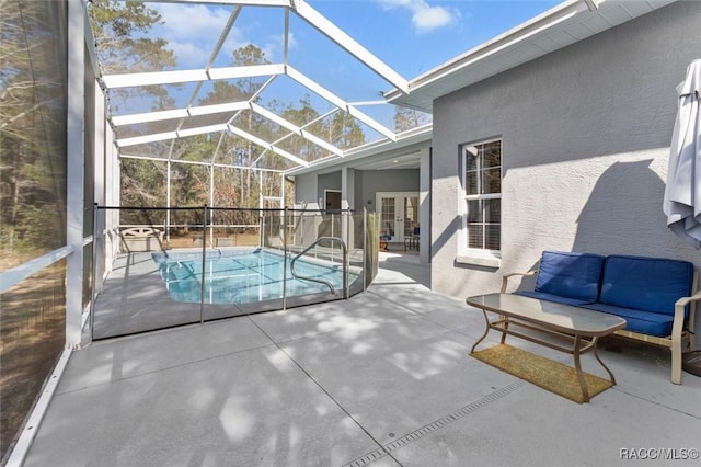 view of swimming pool with glass enclosure, outdoor lounge area, french doors, a fenced in pool, and a patio area