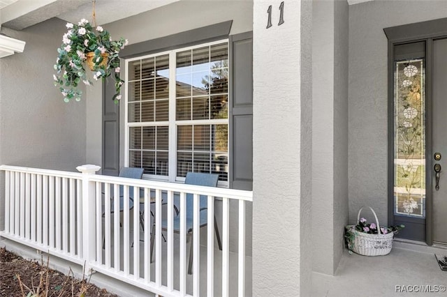 doorway to property featuring stucco siding