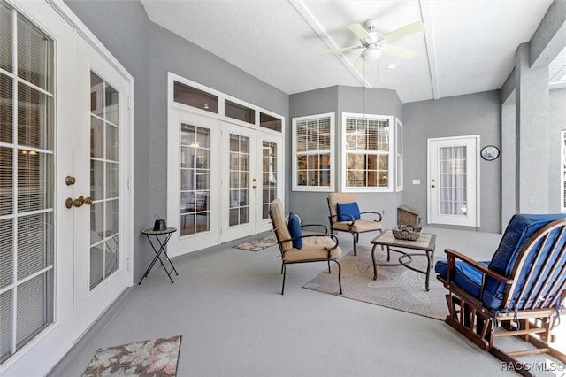 sunroom / solarium with a ceiling fan and french doors