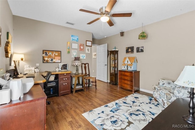 office with a ceiling fan, visible vents, baseboards, and wood finished floors