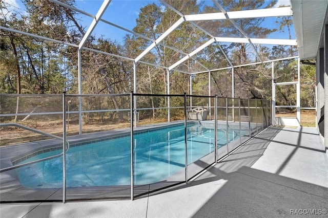 view of pool with glass enclosure and a fenced in pool