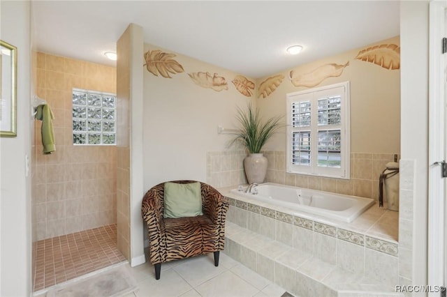 full bath with tile patterned floors, a bath, and a walk in shower