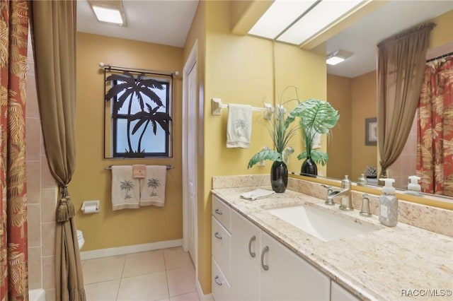 full bath with vanity, a shower with curtain, baseboards, a skylight, and tile patterned flooring