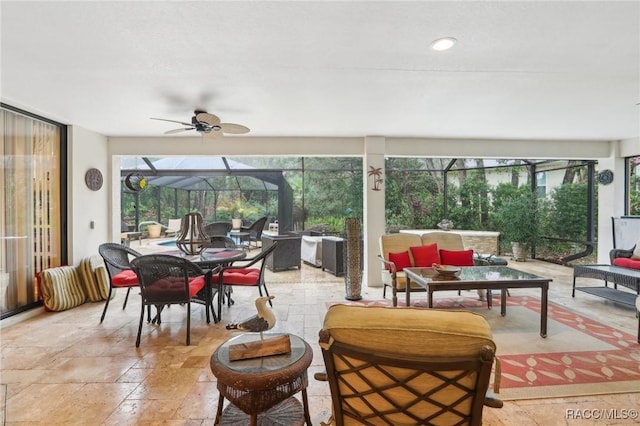 sunroom / solarium featuring ceiling fan