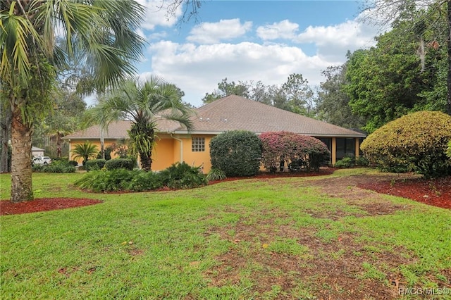 ranch-style house with a front lawn