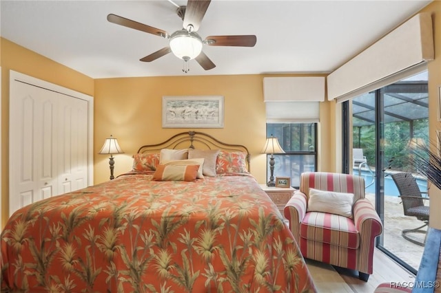 bedroom featuring access to exterior, a closet, a sunroom, and ceiling fan