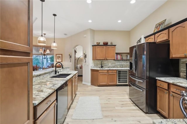 kitchen featuring backsplash, wine cooler, dishwasher, fridge with ice dispenser, and a sink