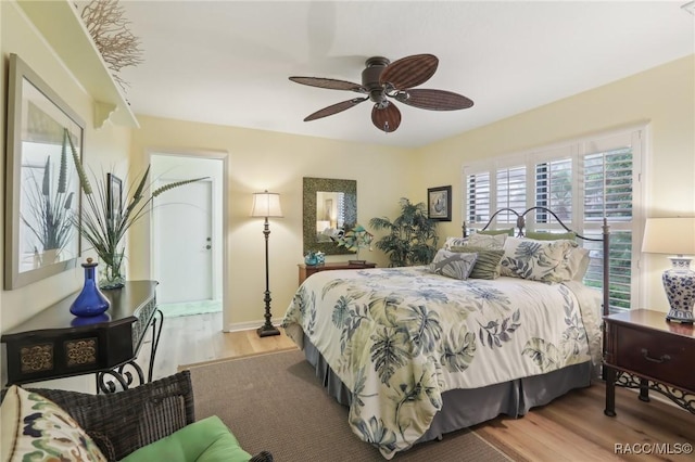 bedroom with baseboards, a ceiling fan, and wood finished floors