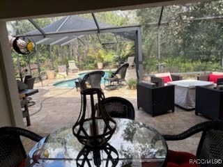 view of patio / terrace with an outdoor pool and a lanai