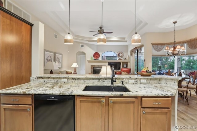 kitchen featuring light stone countertops, visible vents, a sink, black dishwasher, and open floor plan